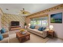 Well-lit living room with comfortable seating and a view of the beautiful backyard at 223 Ne Golf Club Dr, New Smyrna Beach, FL 32168