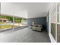 Spacious screened-in lanai featuring tile flooring and comfortable seating area, ideal for relaxation and entertainment at 2325 Lime Tree Dr, Edgewater, FL 32141