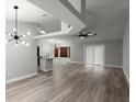 Bright, open-concept living area with new flooring, modern lighting, and seamless flow to the kitchen, perfect for entertaining at 2325 Lime Tree Dr, Edgewater, FL 32141