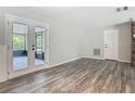 Bright living area featuring wood-look floors and French doors to screened porch at 2628 Vista Palm Dr, Edgewater, FL 32141