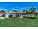 Well-maintained single-story home with a blue door, and a two car garage at 2632 Turnbull Estates Dr, New Smyrna Beach, FL 32168
