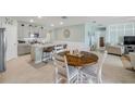 Bright kitchen and dining area featuring stainless steel appliances, a breakfast bar, and a dining table at 2733 Neverland Dr, New Smyrna Beach, FL 32168