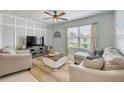 Comfortable living room featuring a large window, neutral paint, stylish furniture, and a ceiling fan at 2733 Neverland Dr, New Smyrna Beach, FL 32168