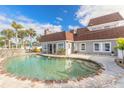 Backyard pool with stone edging, patio area and lush landscaping create a private outdoor oasis at 2900 S Peninsula Dr, Daytona Beach, FL 32118