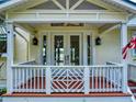 Inviting front porch with a decorative railing and double doors, creating a warm welcome at 2950 Sunset Dr, New Smyrna Beach, FL 32168