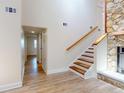 Hallway and staircase next to a stone fireplace and hard wood floors at 2950 Sunset Dr, New Smyrna Beach, FL 32168