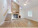 Bright living room boasts a stone fireplace, skylight, and wood-look flooring at 2950 Sunset Dr, New Smyrna Beach, FL 32168