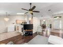 Spacious living room with hardwood floors, modern ceiling fan, and ample natural light at 3231 Bretton Woods Ter, Deltona, FL 32725