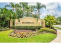 The Maribella community sign is surrounded by lush landscaping and colorful flowers at 3577 Maribella Dr, New Smyrna Beach, FL 32168