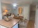 Inviting dining area with a wooden table, neutral walls, bright lighting, and stairway access at 38 Cedar Dunes Dr, New Smyrna Beach, FL 32169