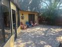 Relaxing brick patio with an array of colorful seating outside an enclosed sunroom at 38 Cedar Dunes Dr, New Smyrna Beach, FL 32169