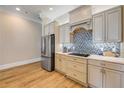 Modern kitchen showcasing custom cabinets, stylish backsplash, and stainless steel refrigerator at 423 S Atlantic Ave # 301, New Smyrna Beach, FL 32169