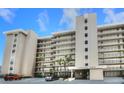Low angle of exterior of building called Sandcastle North, showing entry and multi-story balconies at 4435 S Atlantic Ave # 416, Port Orange, FL 32127