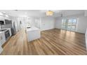 Open-concept living space features wood floors, recessed lighting and large windows at 4620 Riverwalk Village Ct # 7403, Ponce Inlet, FL 32127