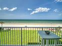 A beautiful balcony view of the ocean and beach with a table to enjoy the fresh air at 5201 S Atlantic Ave # 407A, New Smyrna Beach, FL 32169