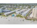 High angle view of a beachfront condo complex showcasing a community pool and manicured landscaping at 525 N Atlantic Ave # 39, New Smyrna Beach, FL 32169