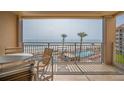 Relaxing condo balcony featuring seating with views of the beach, pools, and ocean at 5501 S Atlantic Ave # 4090, New Smyrna Beach, FL 32169