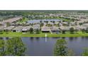 Aerial shot of homes in a lakeside community highlighting the peaceful, waterfront neighborhood at 551 Armoyan Way, New Smyrna Beach, FL 32168