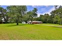 Charming single-story home with a large, well-maintained front yard and mature trees for added privacy at 585 Corbin Park Rd, New Smyrna Beach, FL 32168