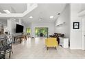 Bright open-concept living room with tile flooring, ceiling fan, and sliding doors to the lanai at 5935 Shady Creek Ln, Port Orange, FL 32128