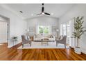 Bright living room with vaulted ceilings, wood floors, and a modern ceiling fan at 620 Middlebury Loop, New Smyrna Beach, FL 32168