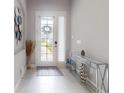 Bright entryway with a glass front door, stylish console table, and modern decor at 6307 Hanfield Dr, Port Orange, FL 32128