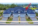Stunning aerial view of townhomes with paved driveways, manicured landscaping and blue toned roofs at 6307 Hanfield Dr, Port Orange, FL 32128