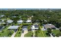 Aerial view of light blue home with a big yard enclosed by a yellow line, showcasing its desirable location at 653 Goodwin Ave, New Smyrna Beach, FL 32169