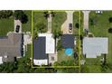Aerial view of light blue home with a dark shingle roof, showcasing the layout of the yard and surrounding area at 653 Goodwin Ave, New Smyrna Beach, FL 32169