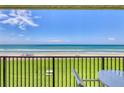 Balcony view showcasing the oceanfront location with pristine beach and inviting outdoor seating, perfect for relaxation and enjoying scenic vistas at 6727 Turtlemound Rd # 318, New Smyrna Beach, FL 32169