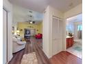 Spacious living room features vaulted ceiling, fan, wood flooring, and views of the home's bathroom and living areas at 686 Middlebury Loop, New Smyrna Beach, FL 32168