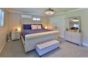 Cozy bedroom with a plush bed, neutral carpet, and updated lighting for a serene and inviting space at 798 Fairway Dr, New Smyrna Beach, FL 32168