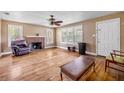 Cozy living room with a fireplace and large windows at 102 N Brooks Cir, Oak Hill, FL 32759