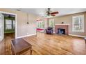 Spacious living room with hardwood floors, fireplace, and lots of natural light at 102 N Brooks Cir, Oak Hill, FL 32759