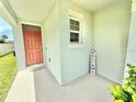 Inviting covered front porch with a stylish front door and a 