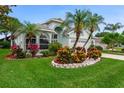 Well maintained lawn and beautiful Florida landscaping surrounds this home at 1221 Siesta Key Cir, Port Orange, FL 32128