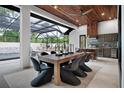 Elegant outdoor dining area with a long table, comfortable chairs, and views of the pool at 1616 Turnbull Crossings Dr, New Smyrna Beach, FL 32168
