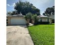 Inviting single-Gathering home with a well-maintained lawn, mature landscaping, and solar panels on the roof at 1743 Jacobs Rd, South Daytona, FL 32119