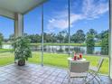 Relaxing screened lanai with scenic lake views, perfect for outdoor seating and enjoying the surrounding nature at 1809 Forough Cir, Port Orange, FL 32128