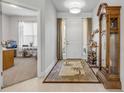 Bright foyer featuring tile floors, a decorative rug, and a glimpse into the adjacent living space at 1929 Pioneer Trl, New Smyrna Beach, FL 32168