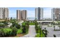Exterior view of condo buildings with well manicured landscaping and green space at 2 Oceans West Blvd # 608, Daytona Beach Shores, FL 32118