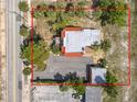 Aerial view of the property with a large parking area and mature landscaping at 20 N Halifax Ave, Daytona Beach, FL 32118