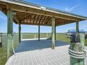 Covered boat dock features sturdy construction and a scenic waterfront view with plenty of open space at 206 S Riverside Dr, Edgewater, FL 32132