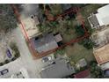 Aerial view of a property outlining its boundaries with surrounding homes and showing the roof and yard condition at 215 Alma Ct, New Smyrna Beach, FL 32168
