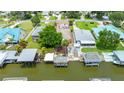 This aerial view shows the home's dock, boats, landscaping and multiple dwellings, including a green roof at 235 Randle Ave, Oak Hill, FL 32759