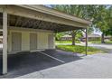 Covered carport providing parking spaces with storage closets for residents convenience at 258 W Sabal Palm Pl # 22, Longwood, FL 32779