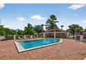 Community pool area with lounge chairs, a covered pavilion, and a well-maintained brick surround at 258 W Sabal Palm Pl # 22, Longwood, FL 32779