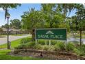 Sabal Place community sign with lush landscaping, pond, and fountain, creating a welcoming entrance at 258 W Sabal Palm Pl # 22, Longwood, FL 32779