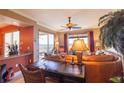 Cozy living room featuring a leather sofa, desk, and a large window with picturesque outdoor views at 265 Minorca Beach Way # 902, New Smyrna Beach, FL 32169