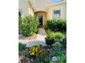 Inviting front entrance with a well manicured garden, enhancing curb appeal at 2672 Star Coral Ln, New Smyrna Beach, FL 32168